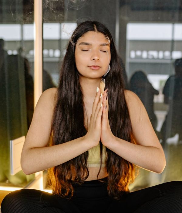 Woman in a calm, centered yoga pose, embodying balance and grace.